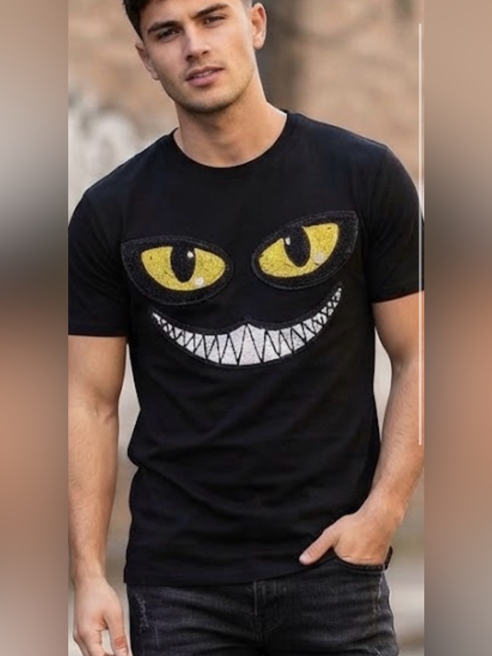 Men's Black Short-Sleeve Graphic Tee with Yellow Eye and White Tooth Design